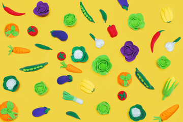 Plasticine vegetables fly into a shopping cart on a yellow background.