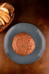 hackepeter - German dish of raw meat seasoned with bread basket. top view on wooden table