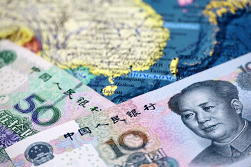 Chinese yuan currency on the map of China. Concept of chinese and asian economy, political conflict over Taiwan