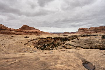 Potholes Dot The Cliff Top On The Edge of A Deep Canyon