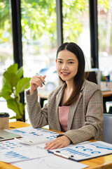 A business analyst or accountant calculates and examines financial documents. Asian businesswoman...
