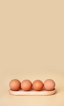 Banner with boiled eggs at wooden server. Easter concept. Copyspace on beige background. Nutritious farm product. High quality photo