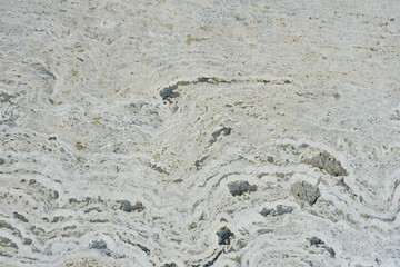 Fototapeta na wymiar Weathered beige stone floor outside in Spain. Bright rough background