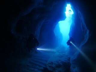 cave diving underwater scuba divers exploring caves and having fun ocean scenery sun beams and rays...