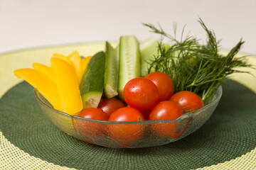 Sliced Fresh Organic Vegetables, Tomatoes, Cucumbers Yellow Pepper and Dill On Plate