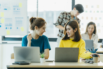 Casual meeting of smiling diverse business team analyzing financial data.