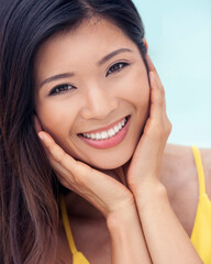 Portrait of beautiful young Asian woman smiling outdoors