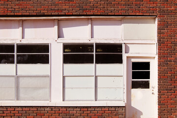 empty abandoned store retail building entrance whitewash window door locked shop - obrazy, fototapety, plakaty