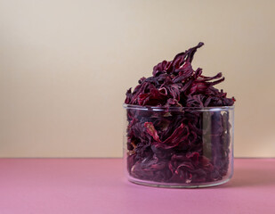 herbal tea, dry hibiskus flower, immune booster in color background © Larisa