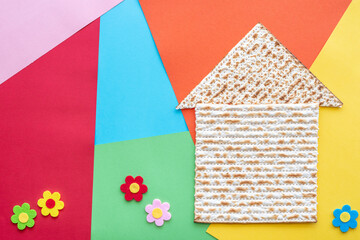 Matzah for Jewish holiday Pesach on colorful background.