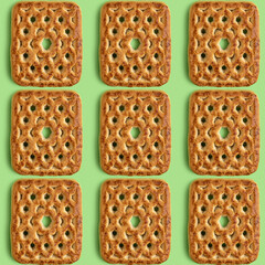 Butter cookies in the form of heart and flower on purple background with copy space.