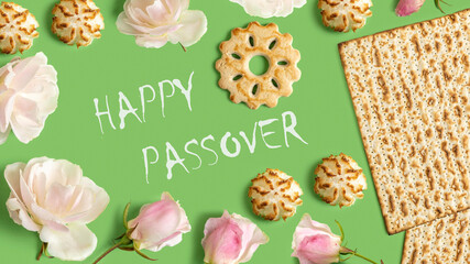 Jewish holiday Passover (Pesach) greeting card with matzah, wine cookies, coconut macaroons, rose flowers on green background.