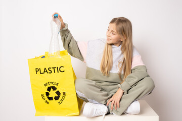 Smiling girl with an ecological bag isolated over a white background. Recycling concept.