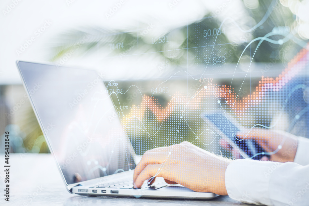 Poster Close up of businessman hand using laptop and smartphone with abstract red forex chart index on blurry outdoor background. Digital data, company and crisis concept. Double exposure.