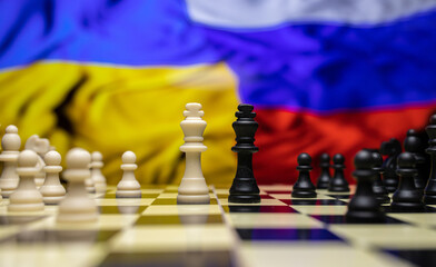 War between Russia and Ukraine, conceptual image of war using chess board, pieces and national...