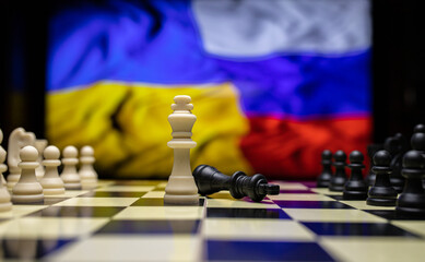 War between Russia and Ukraine, conceptual image of war using chess board, pieces and national flags on the background. Ukrainian & Russian crisis, political conflict. Stop the war 2022 - obrazy, fototapety, plakaty