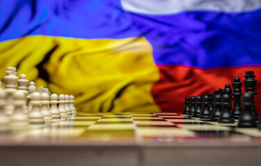War between Russia and Ukraine, conceptual image of war using chess board, pieces and national...