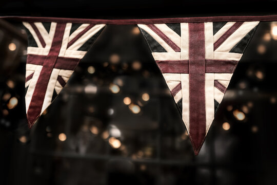 Faded vintage Union Jack bunting with bokeh background. Ideal for platinum jubilee celebrations.