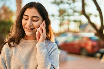 Young middle east girl smiling happy talking on the smartphone at the city.