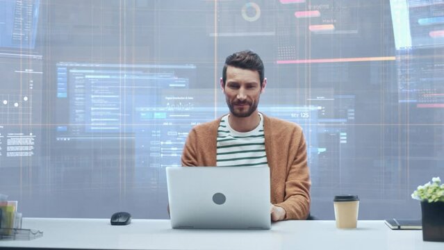 Office Manager with Animated Virtual Background: Businessman Sitting at a Desk Working on a Laptop Computer. Man Working with Big Data Finance Analysis. 360 Degree Tracking Shot. Camera Moving Around.