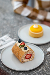 Strawberry filled roll cake on a plate.