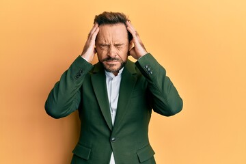 Middle age man wearing business suit suffering from headache desperate and stressed because pain...