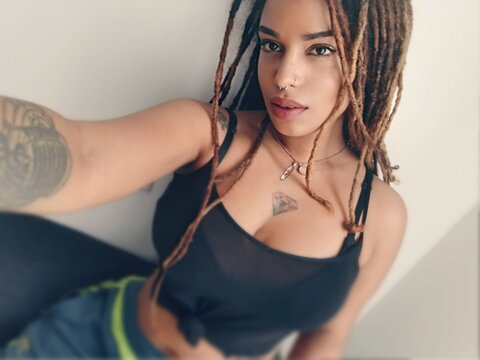 Black woman in strap crop top and dreads