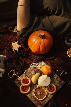 Cropped image of woman beside pumpkin