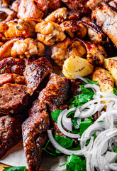 Assorted Mixed different grilled meat with vegetables on table