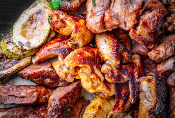 Assorted Mixed different grilled meat with vegetables on table