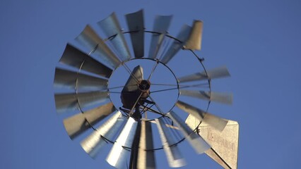 Old windmill turning with the wind on a bright blue sky in Patagonia, Argentina