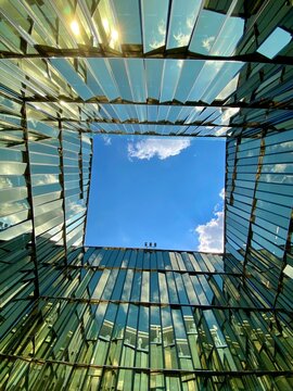 Low angle photography of glass building under blue sky