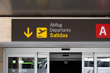 Entrance door of a Spanish International airport with departures, salidas sign.