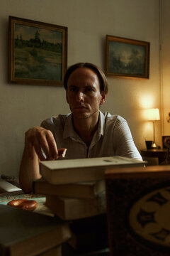 Mature man sitting at a table indoor