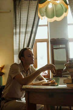 Mature man sitting at a table indoor