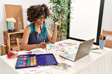 Young african american woman smiling confident having online draw class at art studio
