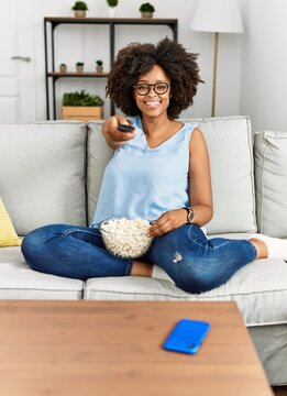 Young African American Woman Smiling Confident Watching Movie At Home