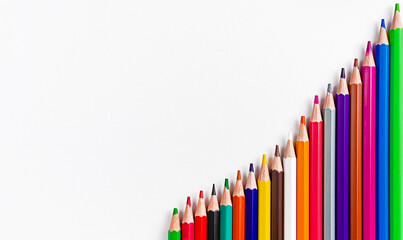 Fototapeta premium Colorful pencils on white background. Flat lay, copy space. Back to school concept