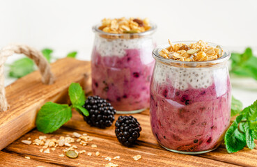 Jars of chia pudding dessert and fresh berries. Healthy dietary eating.
