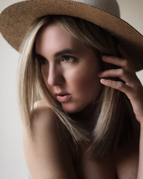 Portrait of young blonde woman wearing a hat