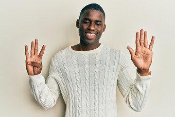 Young african american man wearing casual clothes showing and pointing up with fingers number nine...