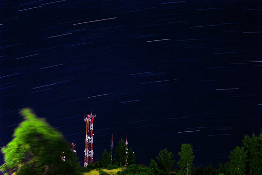 Time lapse photo of stars over utility tower