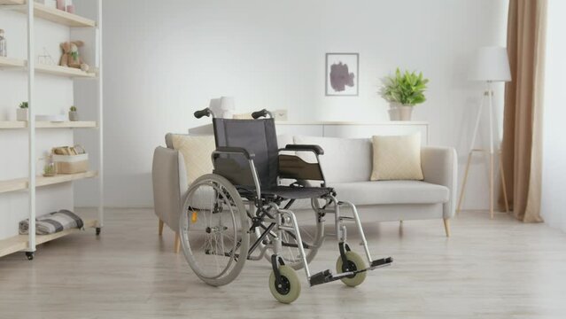Disability and health problems. Zoom in shot of empty wheelchair standing at home. Concept of accidents and traumas