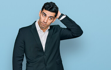 Handsome hispanic man wearing business clothes confuse and wondering about question. uncertain with...