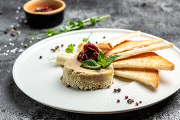 Delicious chicken liver pate with butter and sun-dried tomatoes and bread on plate. Healthy food trend