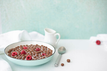 chocolate corn flakes with milk and raspberries
