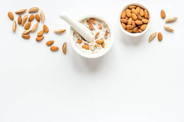 Pestle almond flour - nuts with mortar on kitchen table