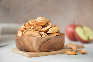 dried red apple slices in a wooden bowl