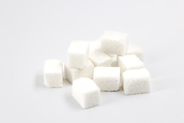 Heap of sugar cubes on white background close-up top view