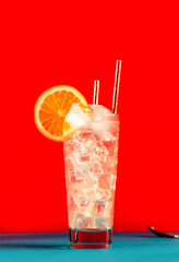 Tom Collins alcoholic cocktail with dry gin, syrup, lemon juice, soda, orange and ice. Defiant red...